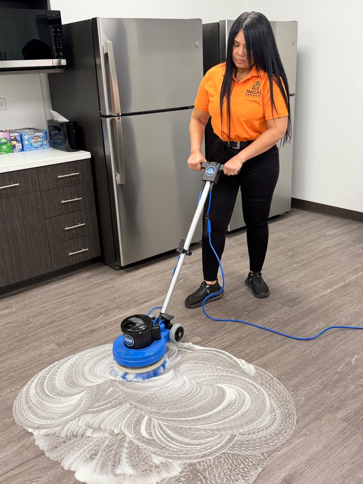 INGAL SERVICES INC employee operating a floor machine at a client facility in Tampa, FL