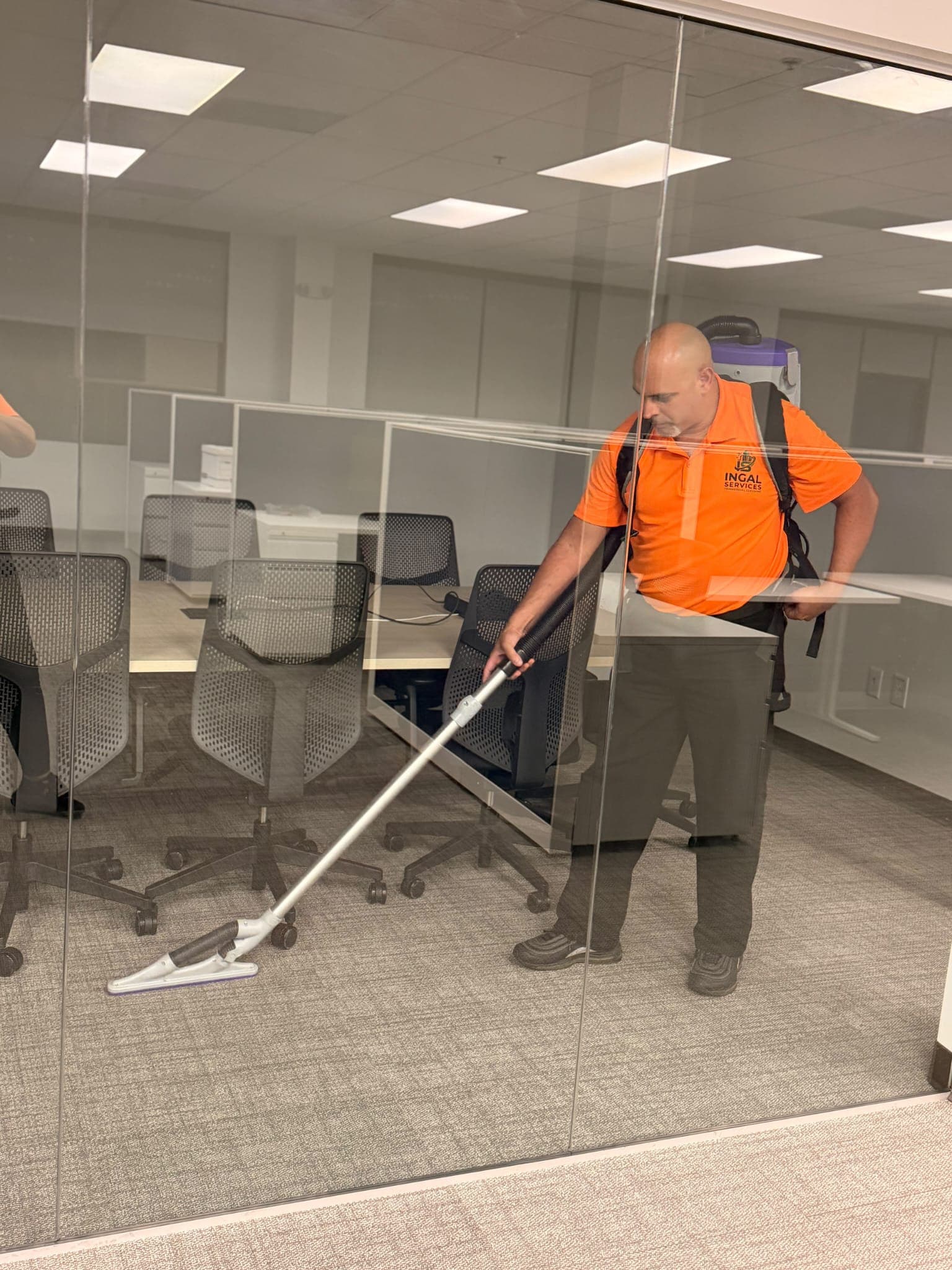INGAL SERVICES INC employee dust mopping an open plan office floor