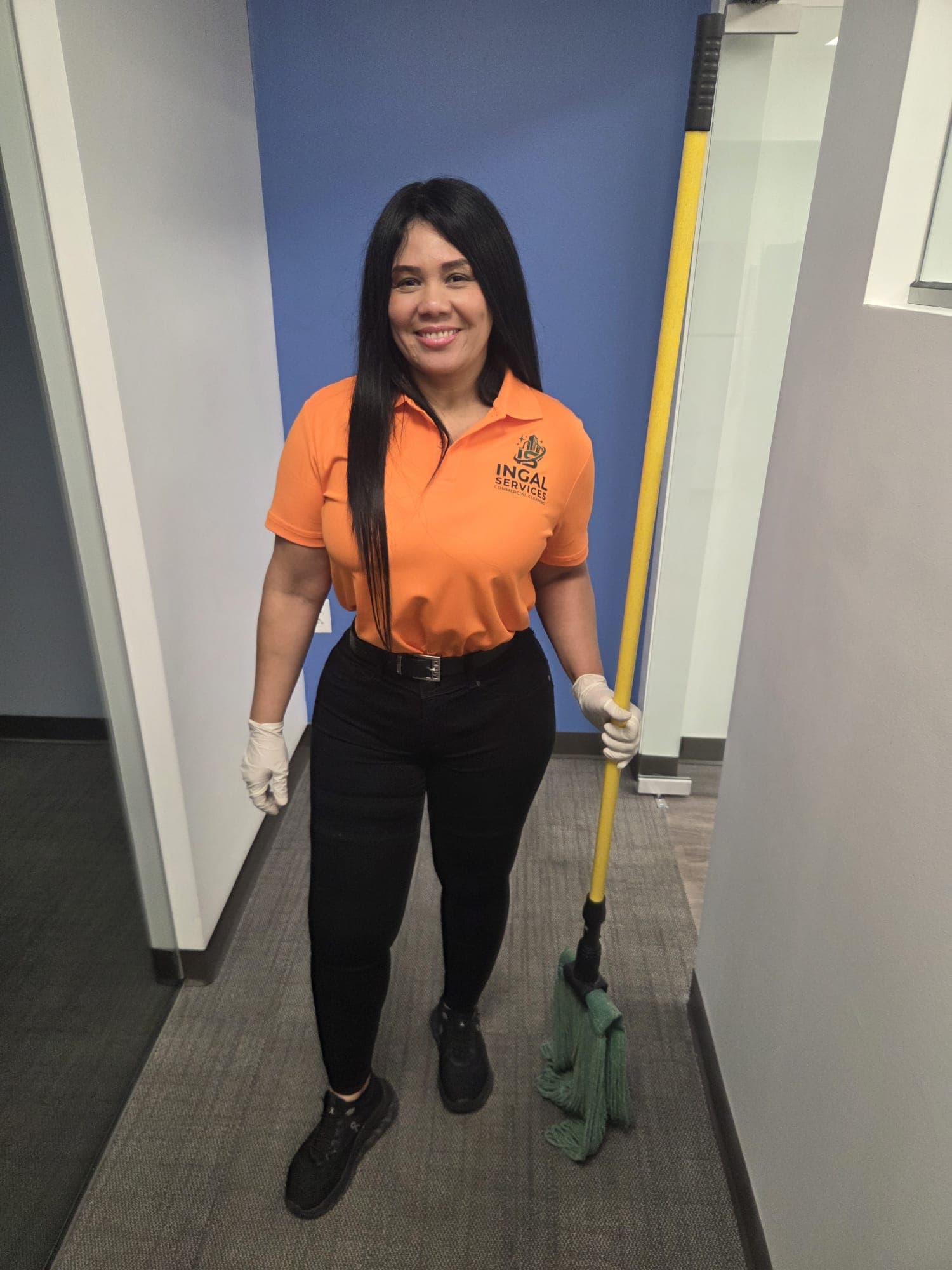 Ingrid Galarza, co-founder of INGAL SERVICES INC, on site with cleaning equipment